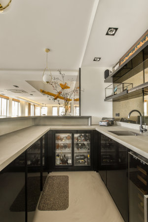 Amsterdam, Netherlands - 10 April, 2021: a modern kitchen with black cabinets and white counter tops in the center of the room is an open area for cookingのeditorial素材