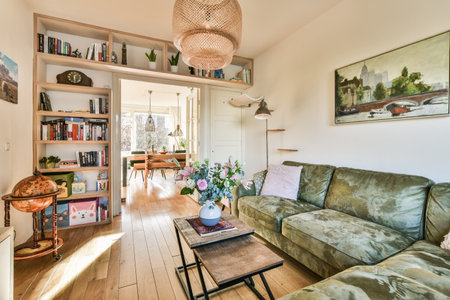 a living room with couches, bookshels and pictures on the wall above it in an open spaceのeditorial素材