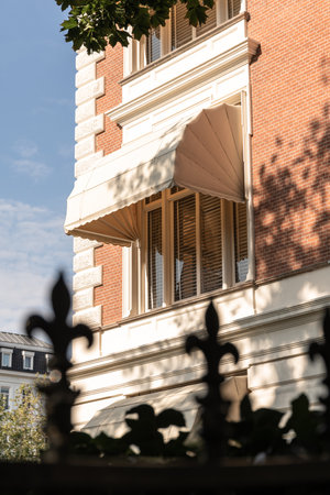a building with a clock on its side and a tree in the fore - swayr, as seen from behindのeditorial素材