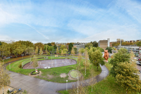 a park in the middle of an urban area with trees and buildings on either side of the road, as seen from aboveのeditorial素材