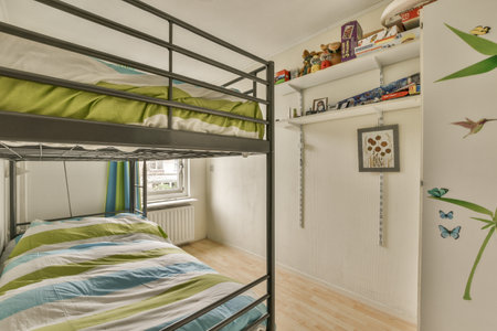 Amsterdam, Netherlands - 10 April, 2021: a kids room with bunks and shelves on the wall above them, all decorated in different colorsのeditorial素材