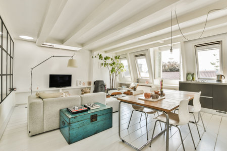 Amsterdam, Netherlands - 10 April, 2021: a living room with white tile flooring and wooden table in the center of the room there is a tv on the wallのeditorial素材