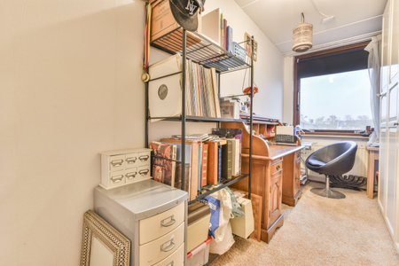 Amsterdam, Netherlands - 10 April, 2021: a home office with lots of stuff on the desks and shelves in front of the window looking out onto the streetのeditorial素材