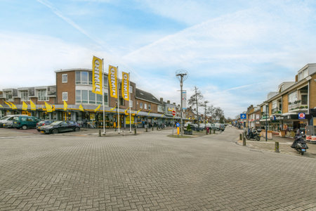 a city street with cars parked on the side and people walking down the road in the middle part of the streetのeditorial素材