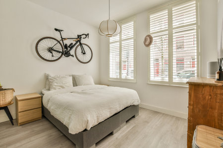 a bedroom with a bicycle mounted on the wall above it and a bed in the room is made out of wood