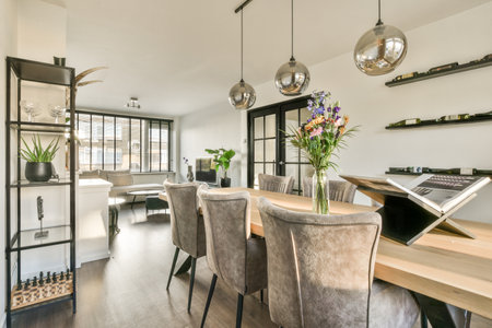 Amsterdam, Netherlands - 10 April, 2021: a dining room with chairs and a laptop on the table in...