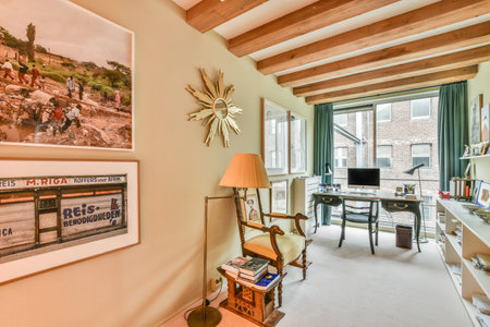 Amsterdam, Netherlands - 10 April, 2021: an old train on the wall in a living room with a desk, chair, and television set hanging above itのeditorial素材