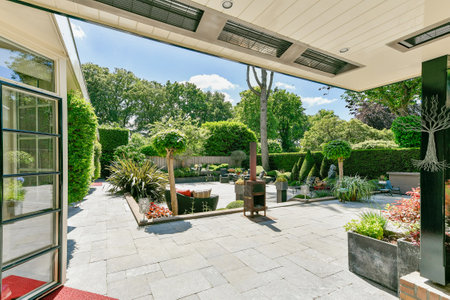 Amsterdam, Netherlands - 10 April, 2021: an outdoor living area with plants and pots on the patio,...