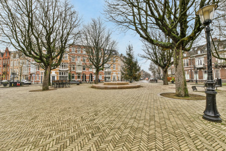 Amsterdam, Netherlands - 10 April, 2021: an empty street in the middle of a small town with trees and buildings on both sides, all lined upのeditorial素材