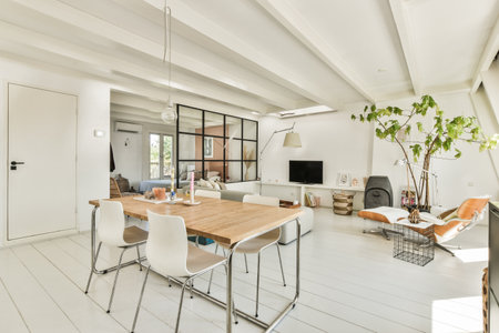 Amsterdam, Netherlands - 10 April, 2021: a living room with white walls and wood flooring in the center of the room is a dining table, two chairs and aのeditorial素材