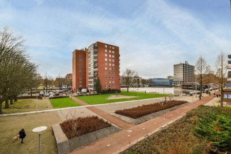 Amsterdam, Netherlands - 10 April, 2021: an urban area with buildings and people walking on the...
