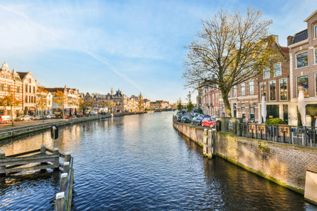 a canal with houses and boats in the fore, taken from an overpassed bridge on a sunny dayのeditorial素材