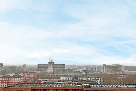 a city with buildings and blue sky in the background, taken from an aerial view point on a cloudy dayのeditorial素材
