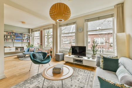 Amsterdam, Netherlands - 10 April, 2021: a living room with couches, chairs and a television set in...