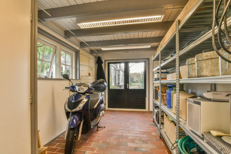 the inside of a house with a motorcycle parked in front of it and an open door leading to another roomのeditorial素材