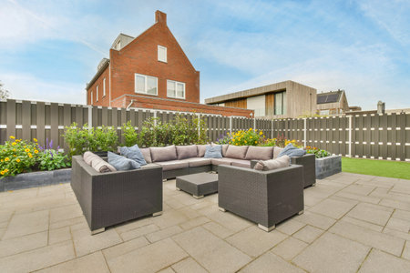 Amsterdam, Netherlands - 10 April, 2021: an outdoor living area with furniture and flowers in the fore - image is taken from outside, its not clearのeditorial素材