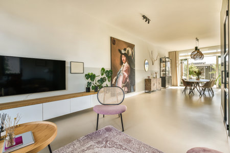 Amsterdam, Netherlands - 10 April, 2021: a woman sitting on a chair in a living room next to a large...
