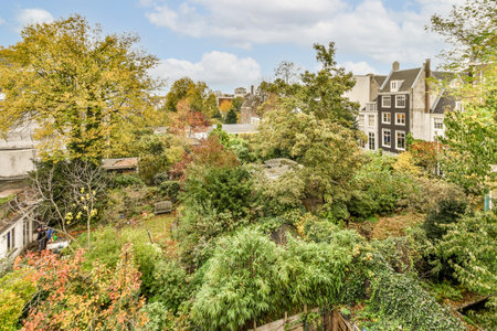 Amsterdam, Netherlands - 10 April, 2021: an urban neighborhood with lots of trees and bushes in the...