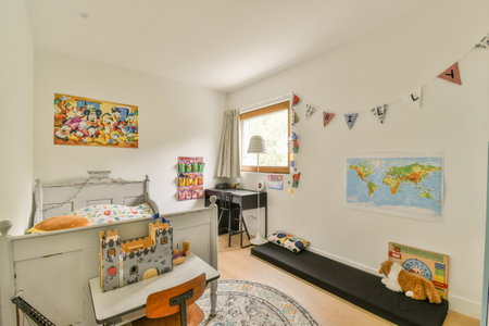 a childs room with toys on the floor and a map hanging above the cribt in the wallのeditorial素材