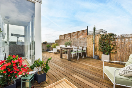 Amsterdam, Netherlands - 10 April, 2021: a deck with chairs and flowers in the pots on the left side of the deck looking out to the backyardのeditorial素材