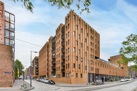 Amsterdam, Netherlands - 10 April, 2021: a building that is made out of wood and brick, on the...
