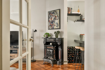 a living room with wood flooring and an open door leading to the dining area that has a wine rack on itのeditorial素材