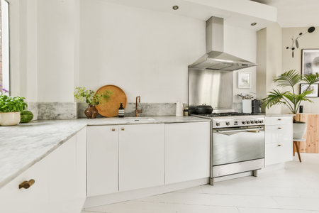 Amsterdam, Netherlands - 10 April, 2021: a modern kitchen with marble counter tops and white cabinets in the photo is taken from the front window to the outsideのeditorial素材