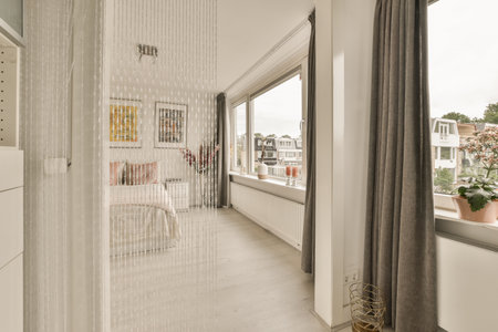 Amsterdam, Netherlands - 10 April, 2021: a living room with white walls and wood flooring on the right side of the room, there is a large window that hasのeditorial素材