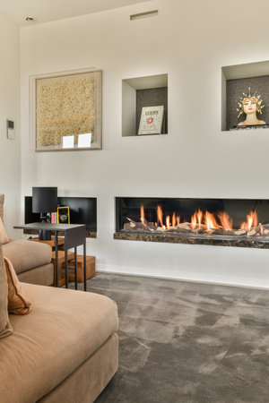 Amsterdam, Netherlands - 10 April, 2021: a living room with a fireplace in the middle and pictures on the wall above it to show what you are looking forのeditorial素材