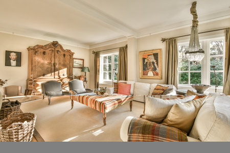 Amsterdam, Netherlands - 10 April, 2021: a living room with couches, chairs and pictures hanging on...
