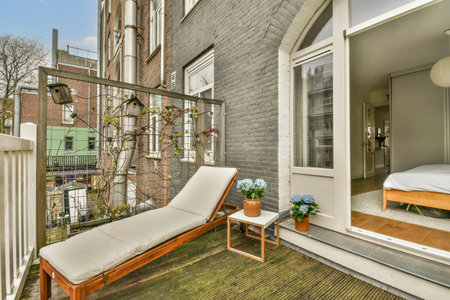 an outside area with a bed, chair, and window in the photo is taken from another room on the other...