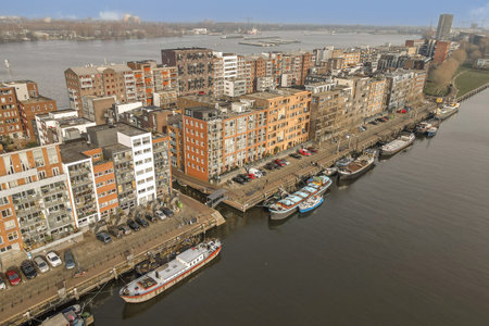 some boats in the water and buildings on the other side of the river that are all connected to each...