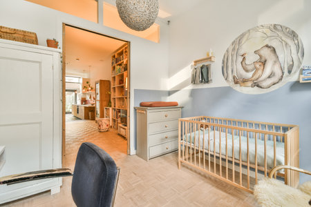 a babys room with a cribt in the corner and an open door leading to another room