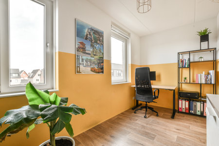 a city is hanging on the wall in this office space with a desk, chair, and bookshele