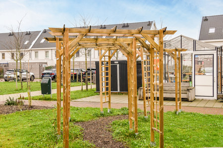 an outdoor area with a wooden structure in the middle and green grass on the ground next to it, there is a blue skyのeditorial素材