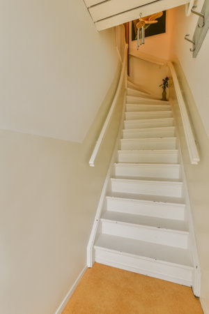 Amsterdam, Netherlands - 10 April, 2021: an empty room with stairs leading up to the second floor and another staircase in the photo is taken from aboveのeditorial素材