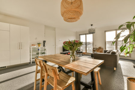 a dining table and chairs in a room with an open door leading to the living area that looks out onto...