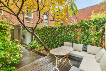 Amsterdam, Netherlands - 10 April, 2021: an outdoor living area with wooden decking and white sofas,...