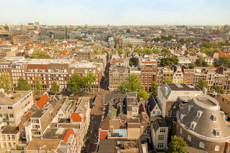 Amsterdam, Netherlands - 10 April, 2021: a city from the top of a building with lots of buildings and trees in the fore - image is taken from aboveのeditorial素材