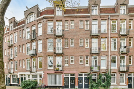 Amsterdam, Netherlands - 10 April, 2021: an apartment building with many windows and balks on the...