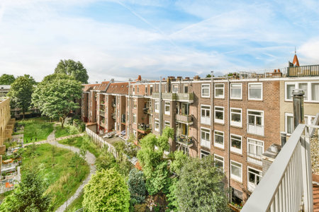 Amsterdam, Netherlands - 10 April, 2021: an apartment with lots of trees and bushes in the fore - image courtesy from real estate agents websiteのeditorial素材