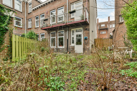 an outside view of a house with plants and bushes in the fore - image taken from google street,...