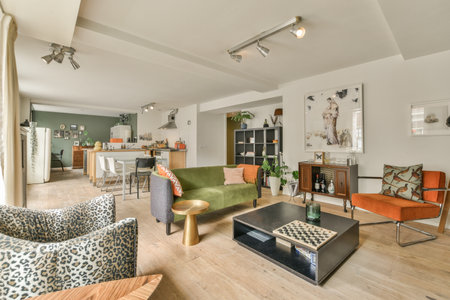 a living room with couches, chairs and coffee table in the center of the room is an open kitchen