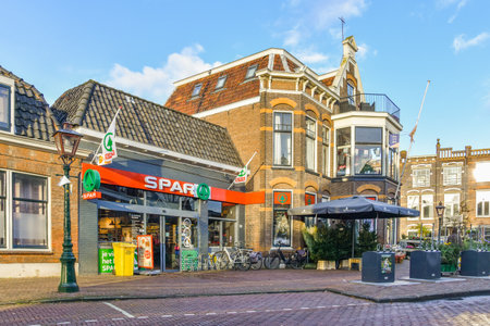a street with buildings and shops in the middle part of the photo is taken on a sunny, clear dayのeditorial素材
