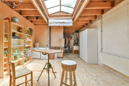 Amsterdam, Netherlands - 10 April, 2021: a kitchen and dining area in an old house with wood floors, exposed walls, wooden ceilings and skylightsのeditorial素材