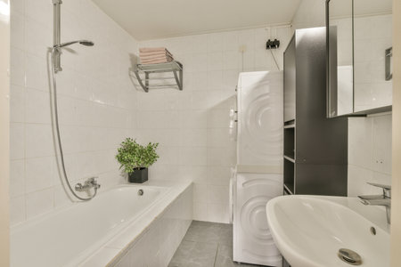 a bathroom with a sink, toilet, and washbast in the corner next to the bathtub is white