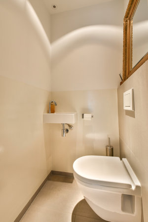 a bathroom with a toilet and mirror in its corner, taken from the top down to the floor