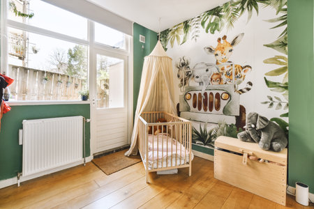 a babys room with animals on the wallpaper and wooden furniture, including a cribe bedの写真素材