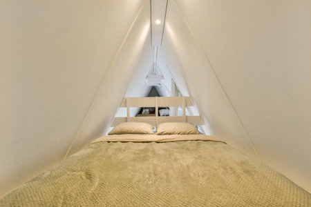 a bed in a room with a mirror on the wall above it and an open door leading to another room
