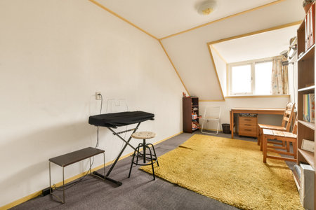 a room with a chair, desk and bookcases on the floor next to an open door that leads to a window